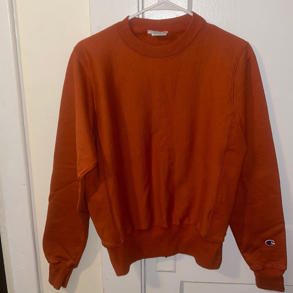 Rusty orange colored crew neck champion woman’s sweatshirt size xtra small